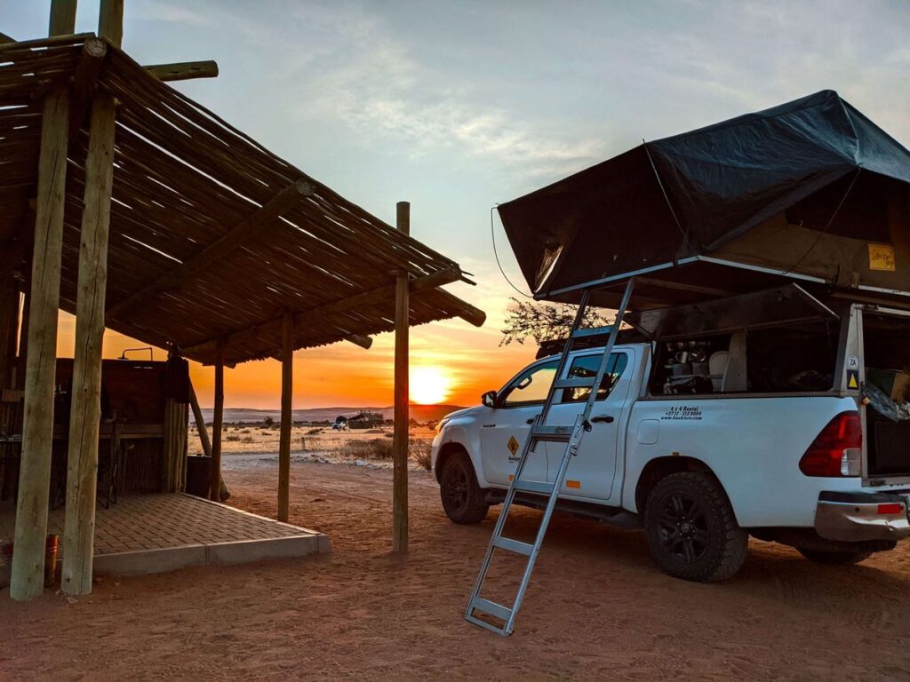 setting up a rooftop tent on a toyota Hilux Rental Uganda