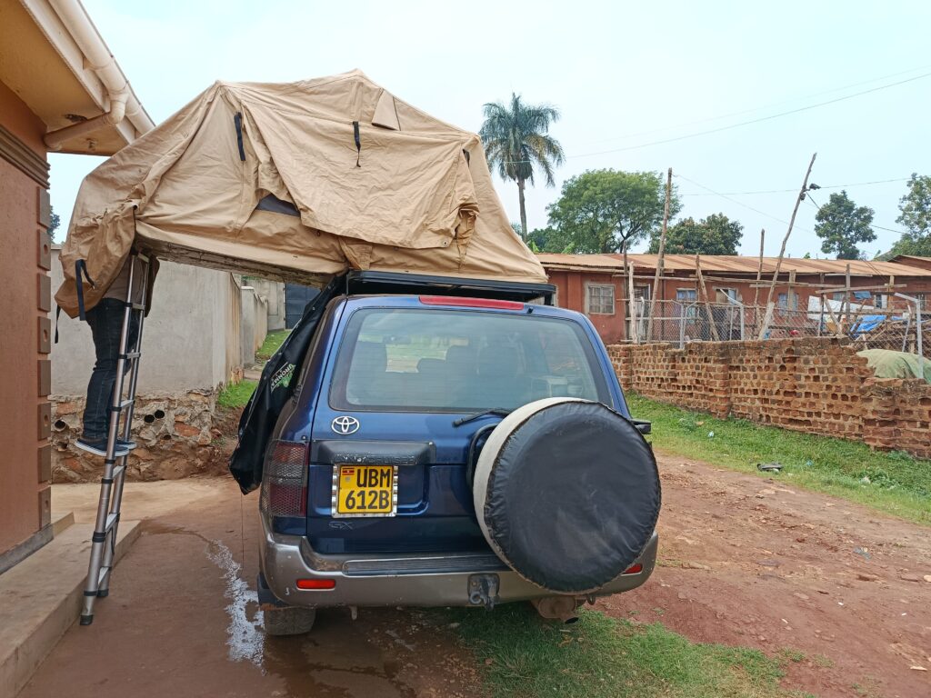 the concept of a land Cruiser (GX/GXL) Rental Uganda with a rooftop tent